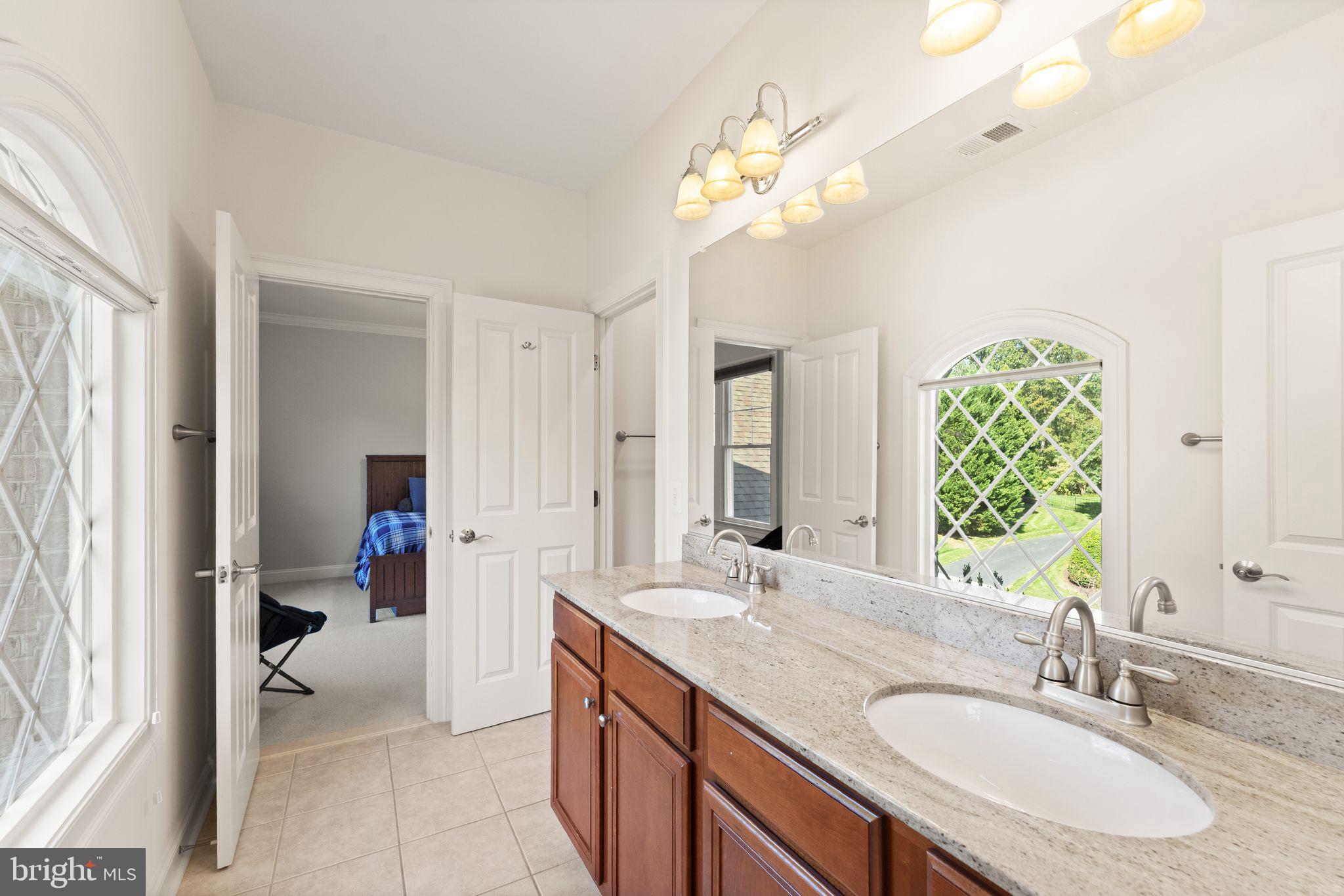 9603 Thistle Ridge Lane Vienna, VA 22182 - Photo 47 of 73 a bathroom with a sink double vanity and a mirror