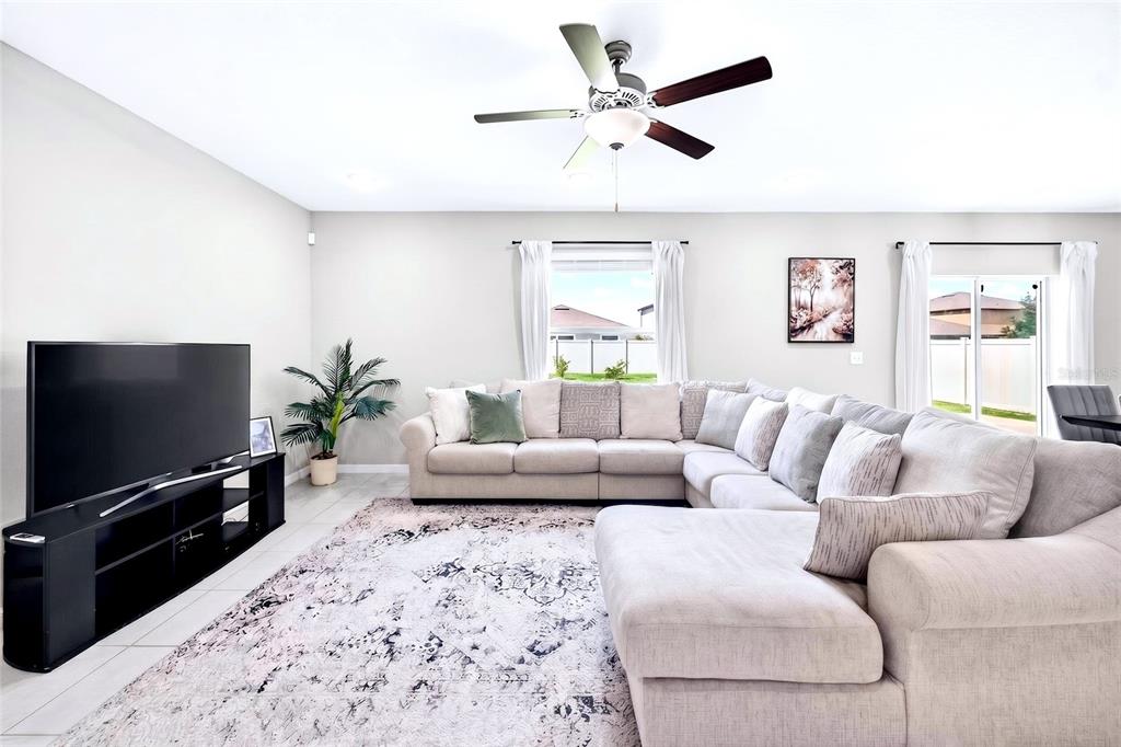 31724 Sun Kettle Loop Wesley Chapel, FL 33545 - Photo 12 of 49 a living room with furniture and a flat screen tv
