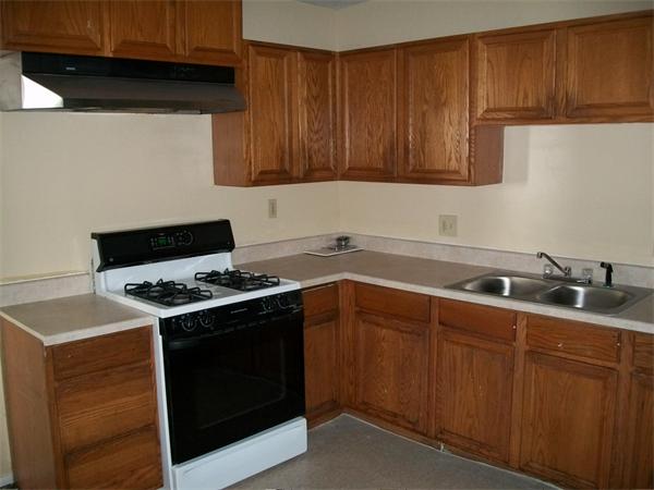 63 Greene Street Springfield, MA 01109 - Photo 6 of 19 a kitchen with a stove sink and cabinets