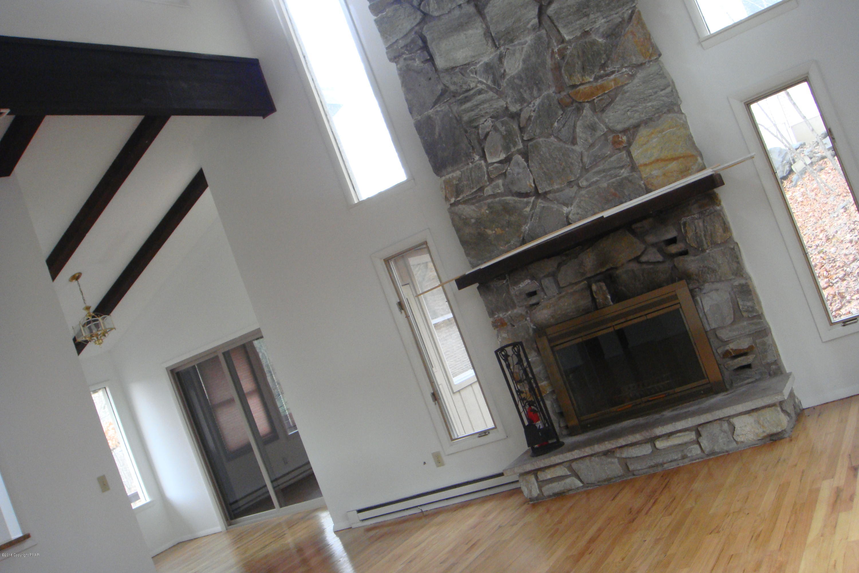 6375 Decker Road Bushkill, PA 18324 - Photo 28 of 60 a view of an empty room with wooden floor and stairs
