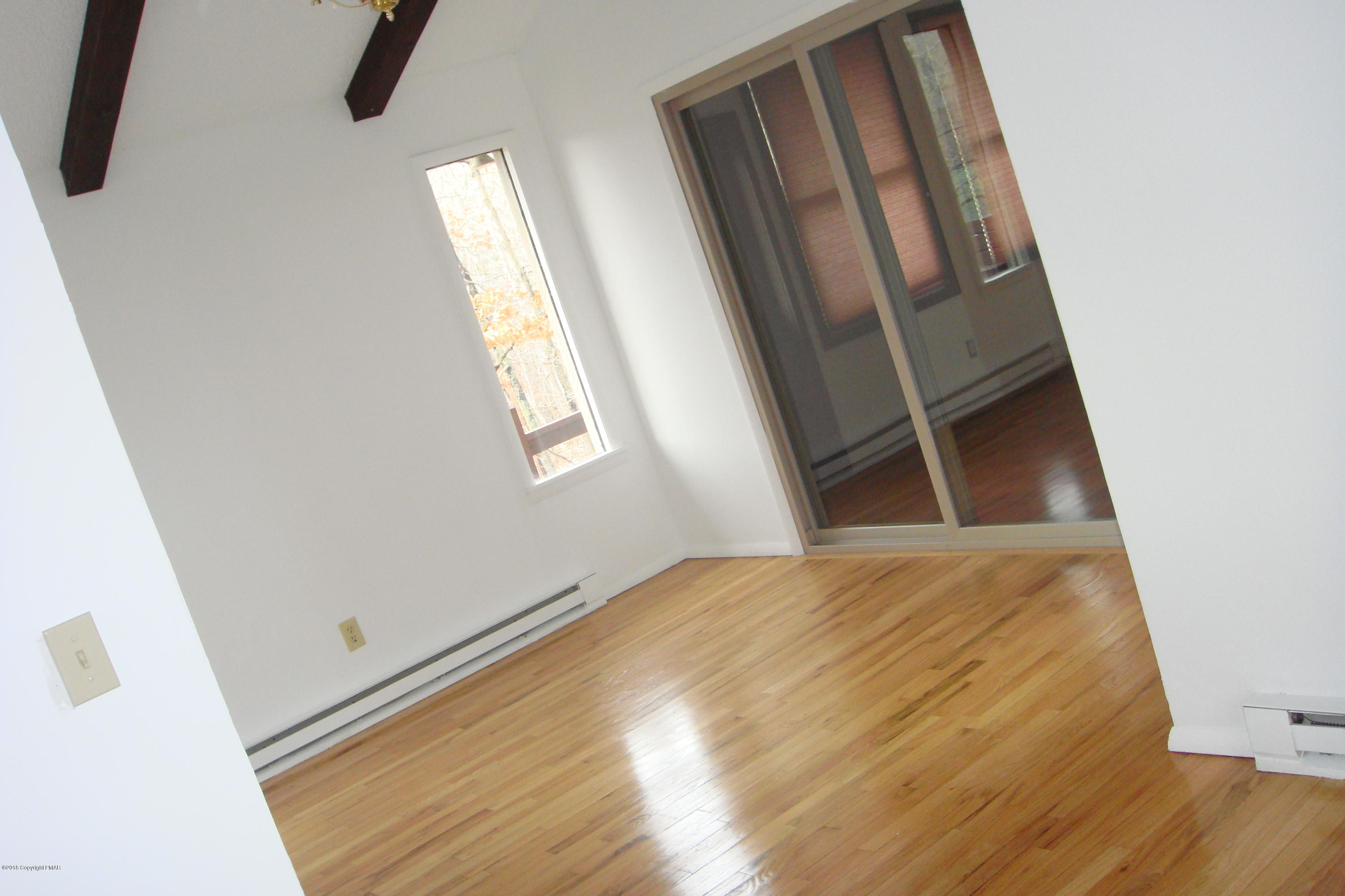 6375 Decker Road Bushkill, PA 18324 - Photo 31 of 60 a view of an empty room with wooden floor and a window
