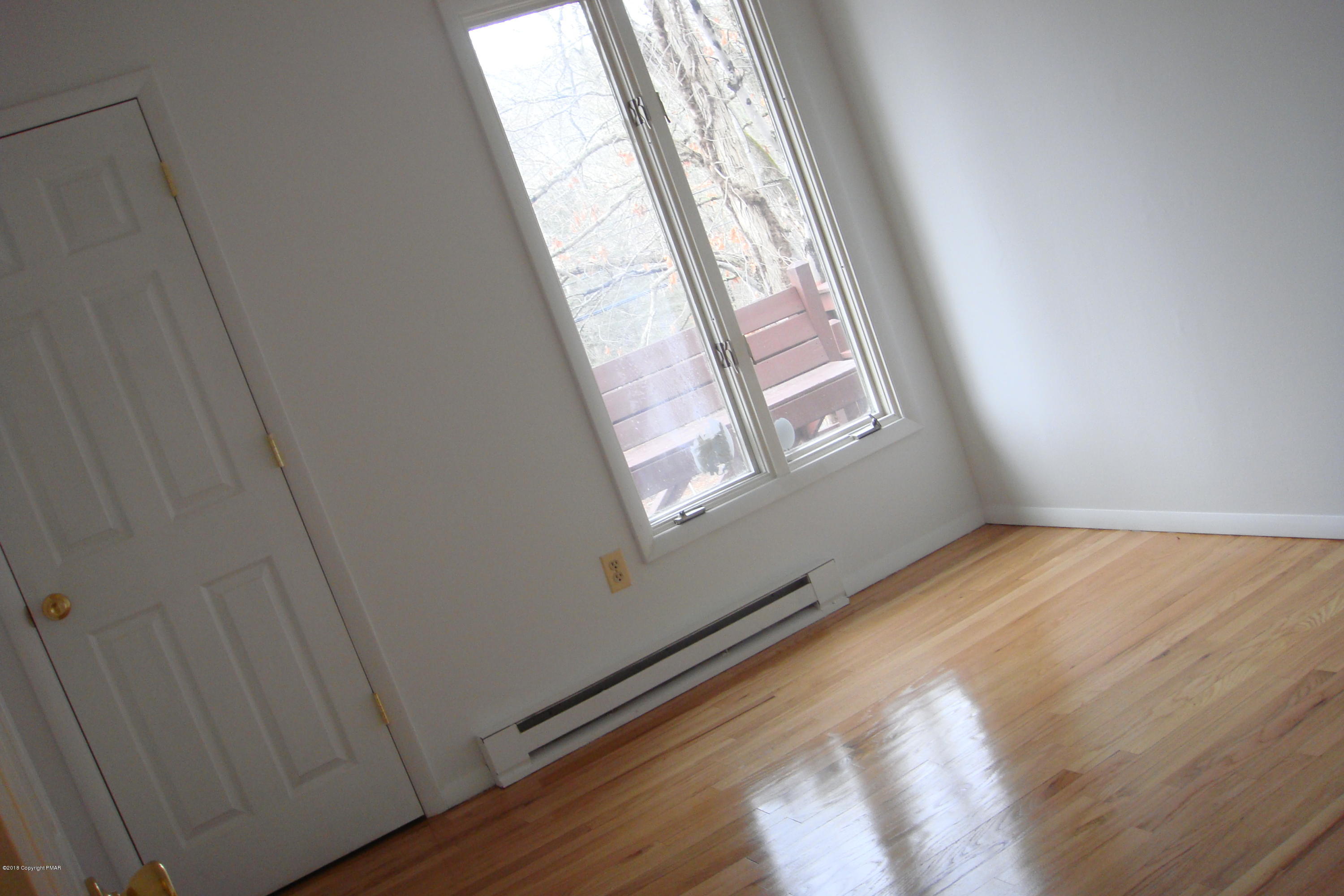 6375 Decker Road Bushkill, PA 18324 - Photo 42 of 60 a view of an empty room with wooden floor and a window