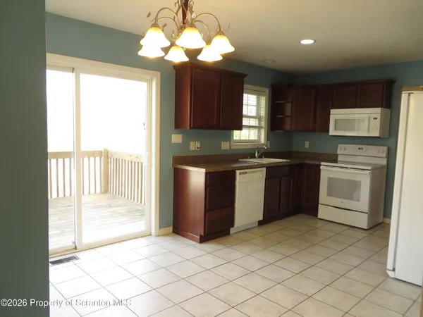 a kitchen with a refrigerator sink and cabinets