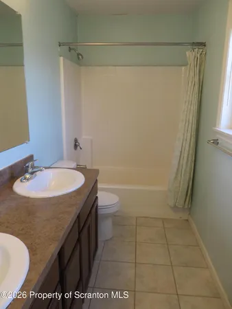 a bathroom with a sink a toilet and tub