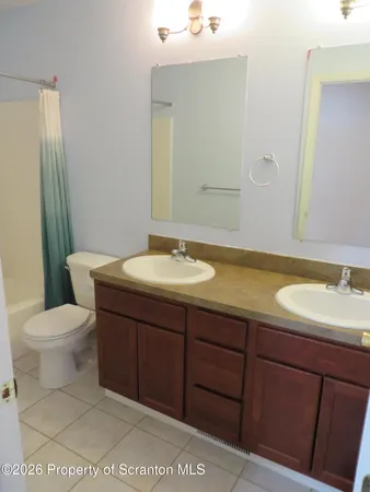 a bathroom with a shower curtain and a toilet
