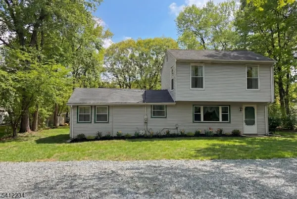a view of a house with yard and a garden
