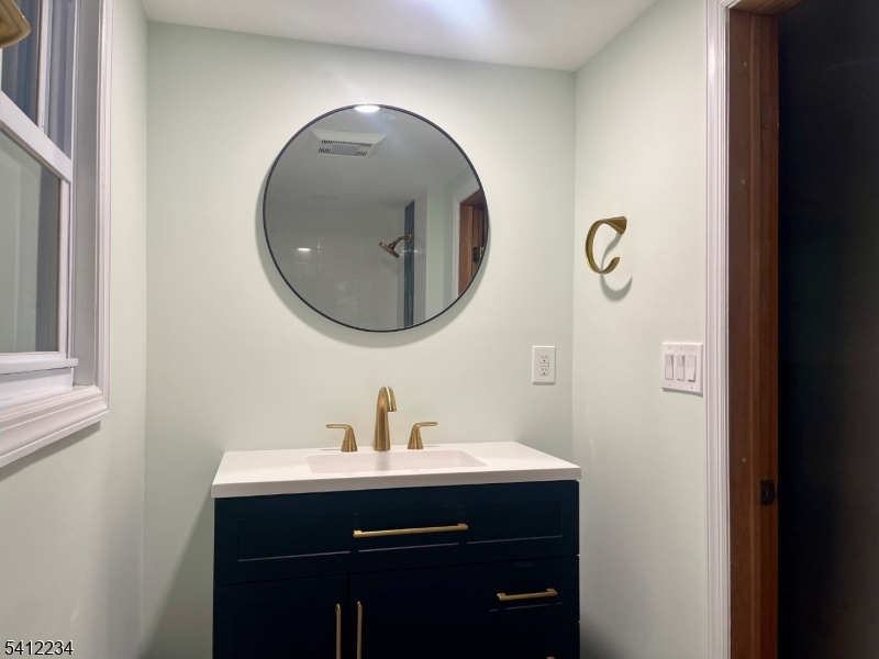 903 Green Pond Road Rockaway, NJ 07866 - Photo 11 of 13 a bathroom with a sink and a mirror
