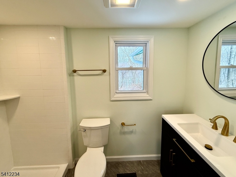 903 Green Pond Road Rockaway, NJ 07866 - Photo 10 of 13 a bathroom with a sink mirror vanity and toilet