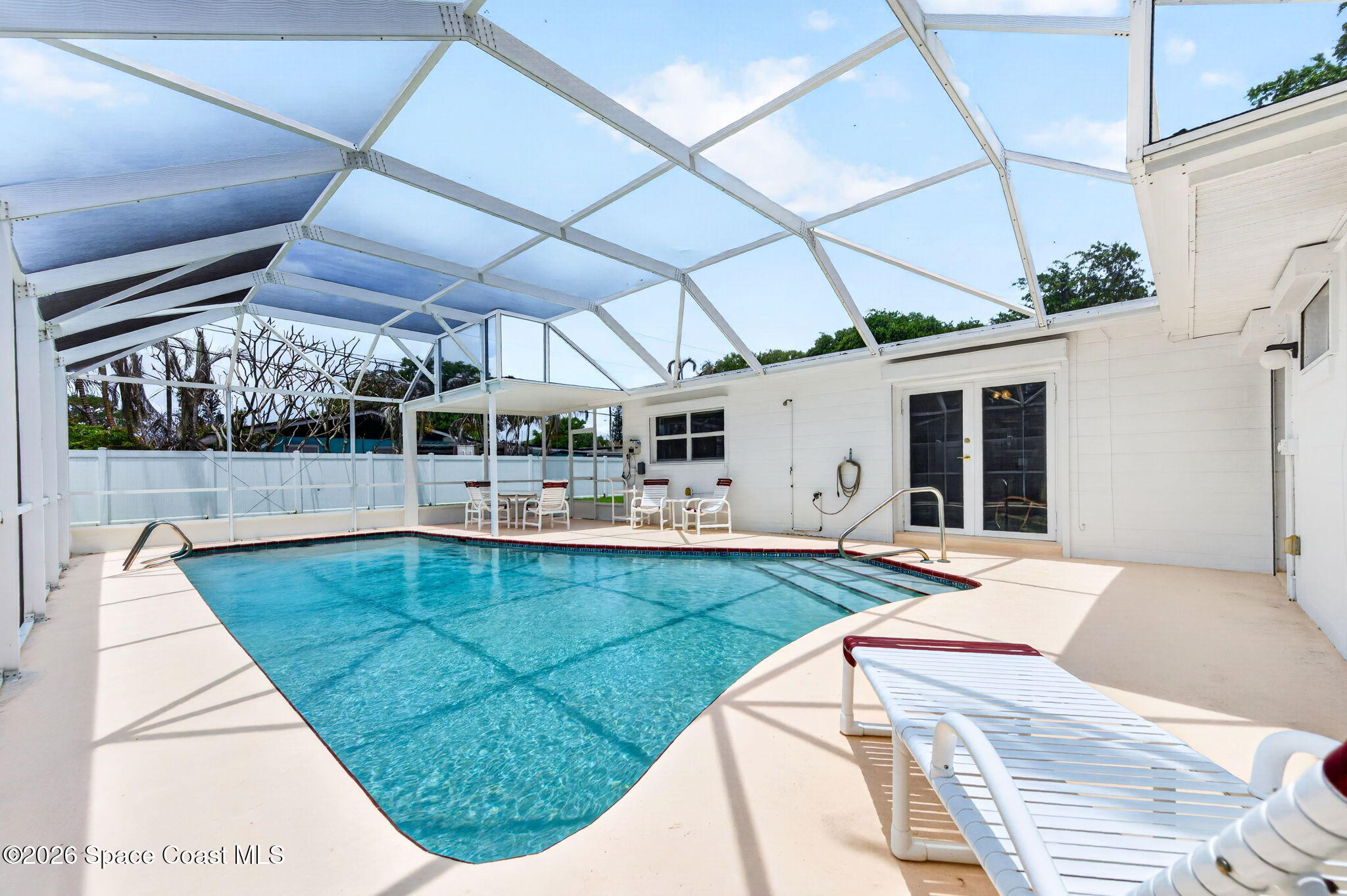 935 Samar Road Cocoa Beach, FL 32931 - Photo 18 of 22 a view of a swimming pool with a patio