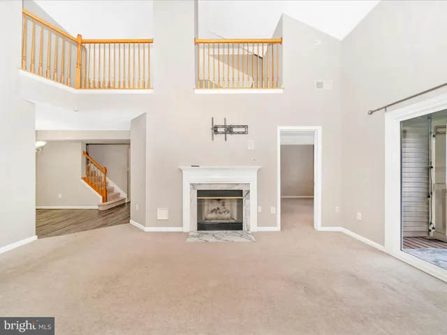 a view of an empty room with a fireplace and a window