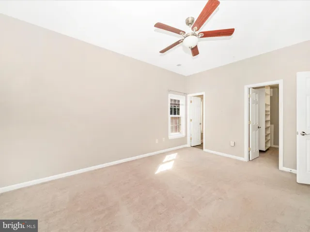 a view of a livingroom with a ceiling fan and window