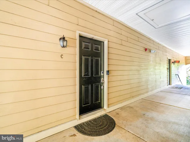 a view of a house with garden and trees
