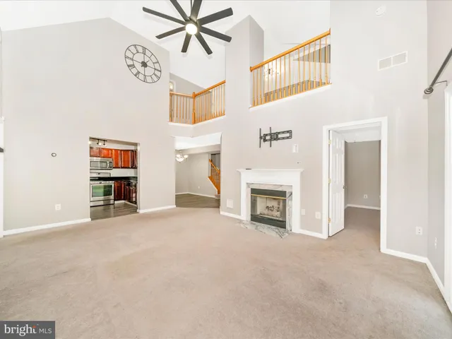 an entryway with a fireplace and fan