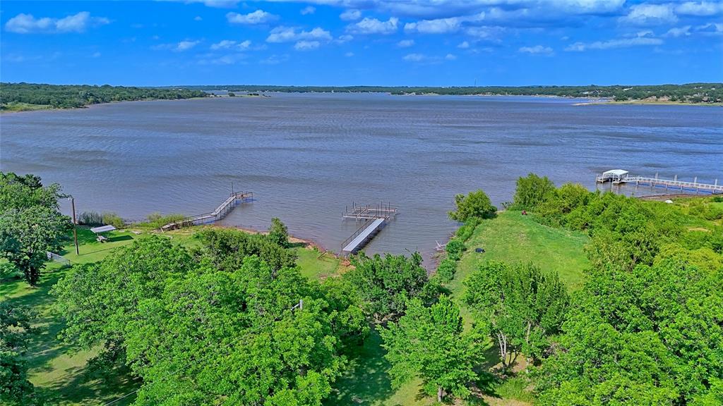 140 Elm Road Nocona, TX 76255 - Photo 4 of 26 a view of a lake with a yard