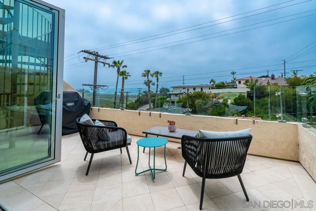 2508 Manchester Avenue Cardiff, CA 92007 - Photo 11 of 75 a view of a patio with a table chairs and a floor to ceiling window