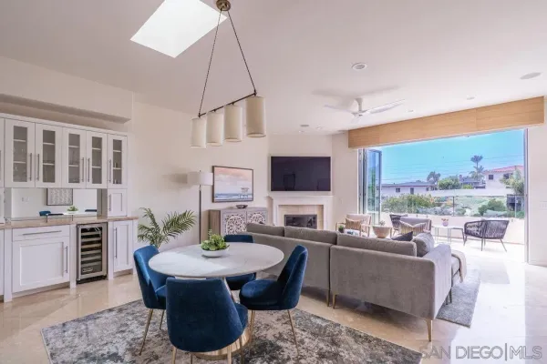 a living room with furniture potted plant and a window