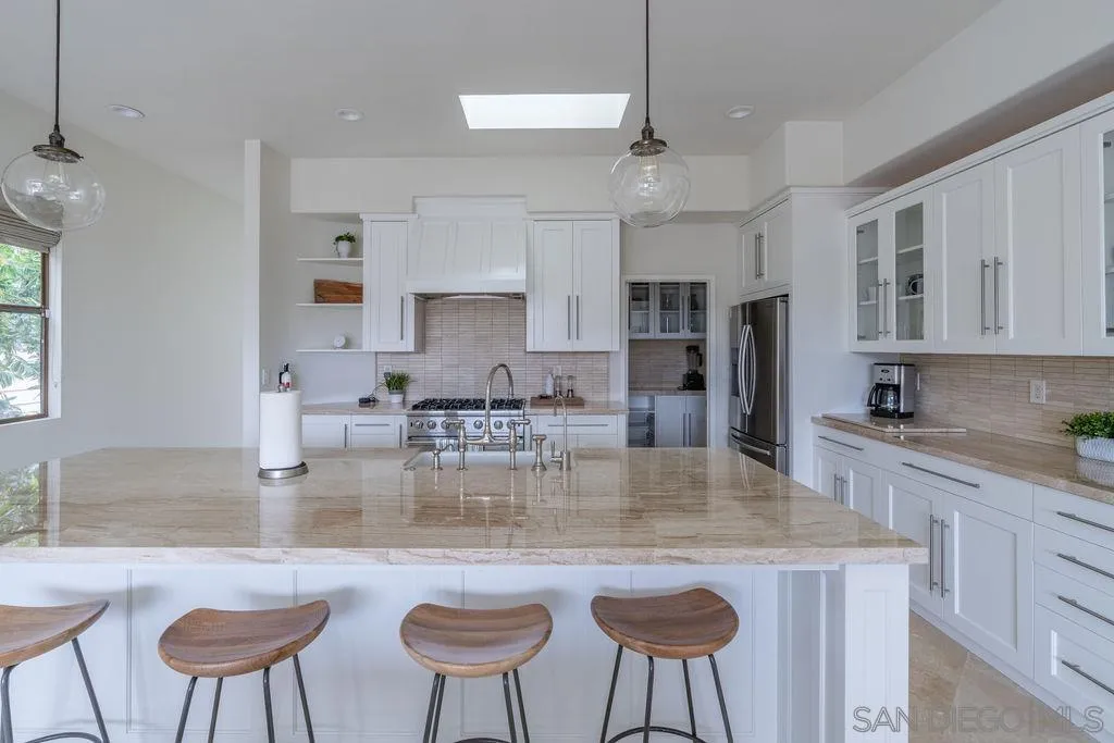 2508 Manchester Avenue Cardiff, CA 92007 - Photo 17 of 75 a kitchen with stainless steel appliances granite countertop a kitchen island a table and chairs in it