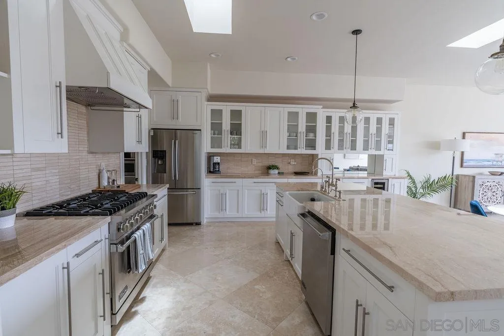 2508 Manchester Avenue Cardiff, CA 92007 - Photo 19 of 75 a kitchen with stainless steel appliances granite countertop a stove a sink dishwasher a refrigerator and a oven with wooden floor
