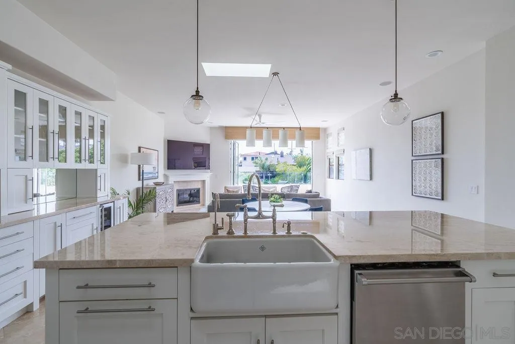 2508 Manchester Avenue Cardiff, CA 92007 - Photo 22 of 75 a kitchen with a sink dishwasher a stove and a microwave oven with cabinets