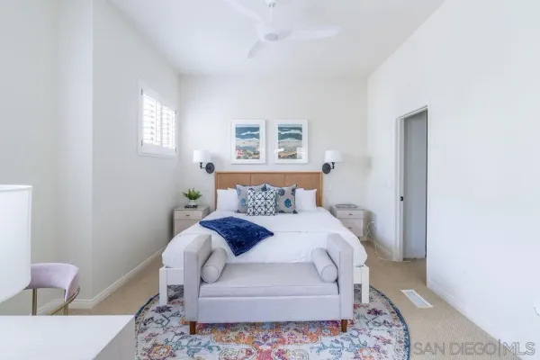 a bedroom with a bed and a painting on the wall