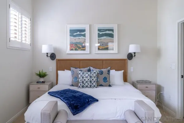 a bedroom with a bed tv and window