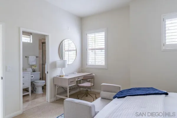 a view of bathroom with a toilet a sink and mirror