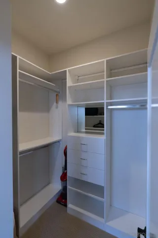 a bathroom with a granite countertop double vanity sink a mirror and a bathtub