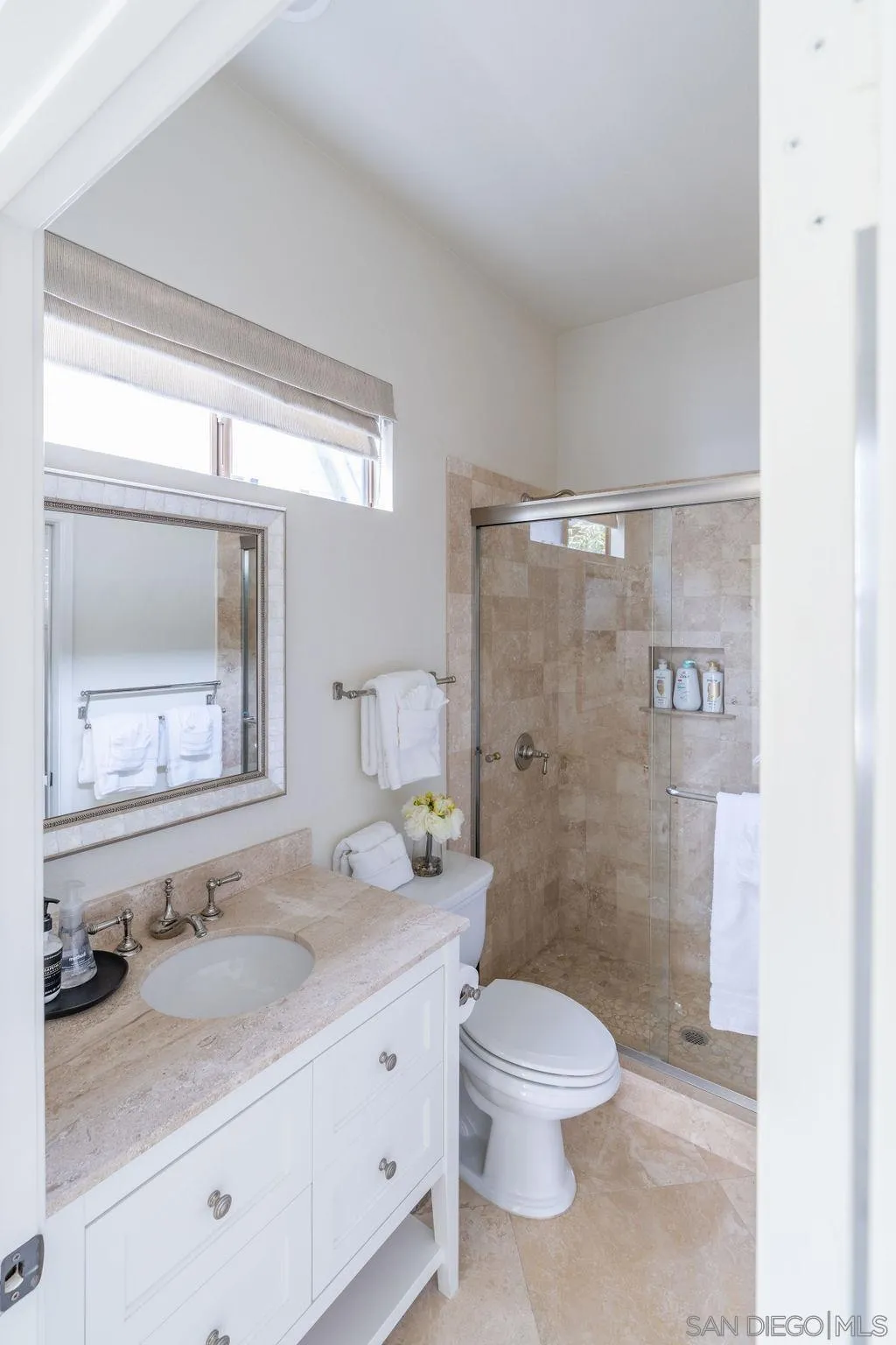 2508 Manchester Avenue Cardiff, CA 92007 - Photo 38 of 75 a bathroom with a granite countertop sink toilet a large mirror and shower