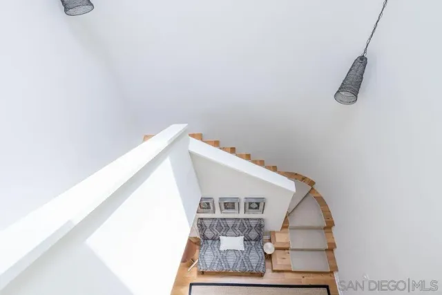 a bedroom with a bed potted plant and a window