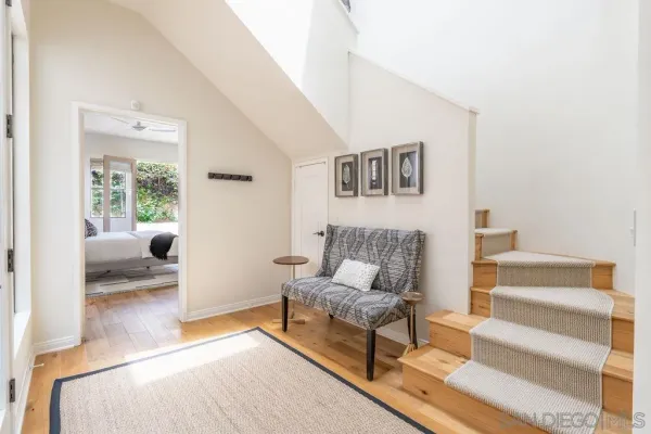 a view of a hallway view with wooden floor and furniture