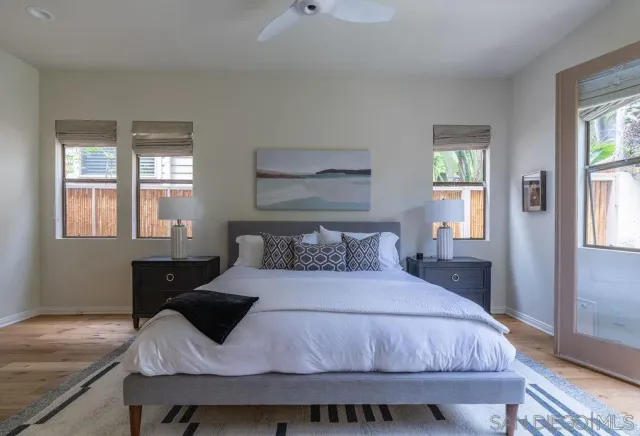a living room with furniture a flat screen tv and a window