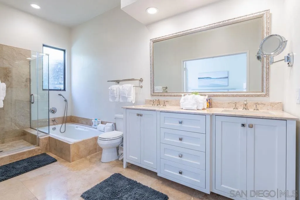 2508 Manchester Avenue Cardiff, CA 92007 - Photo 50 of 75 a bathroom with a granite countertop double vanity sink a mirror and a bathtub