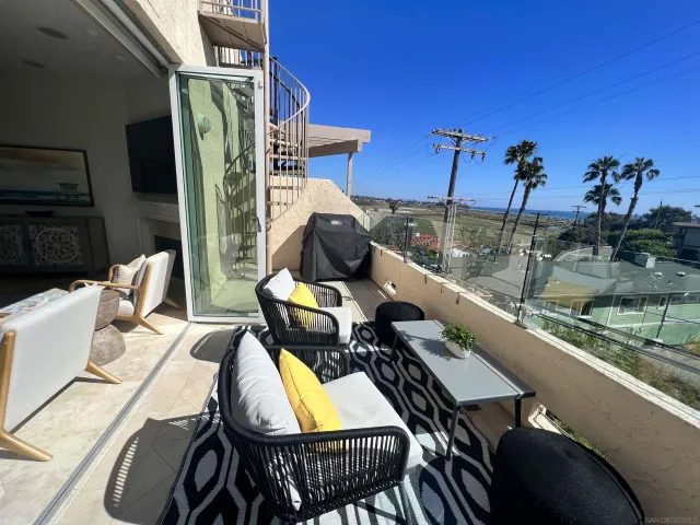 a living room with furniture and a view of kitchen