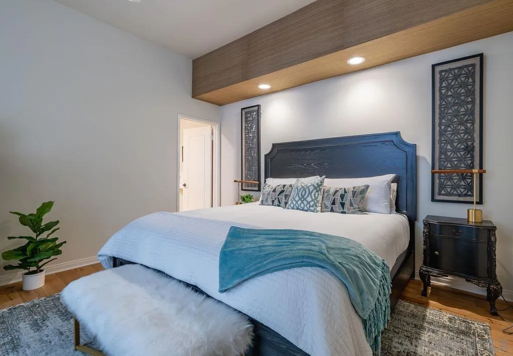2508 Manchester Avenue Cardiff, CA 92007 - Photo 60 of 75 a bedroom with a large bed and a potted plant