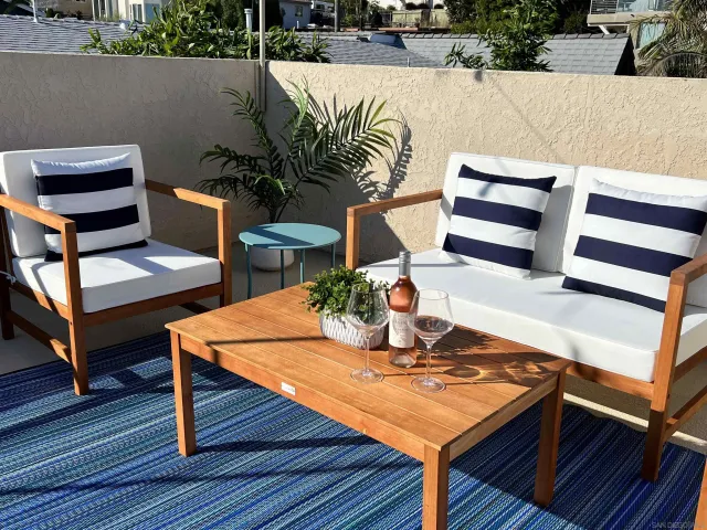 a living room with furniture a flat screen tv and a table