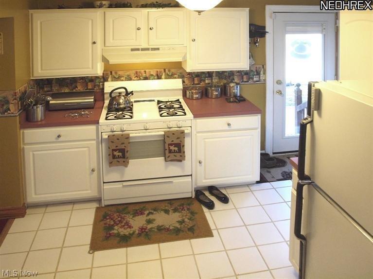 3015 Patton Street Northwest Canton, OH 44708 - Photo 5 of 16 Ceramic tile floors bring additional light into the kitchen. Also notice the side entrance which makes off-loading groceries convenient.