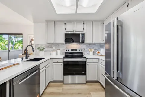 a kitchen with a stove sink and refrigerator