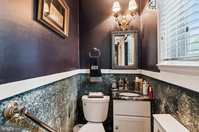 a bathroom with a toilet sink and mirror