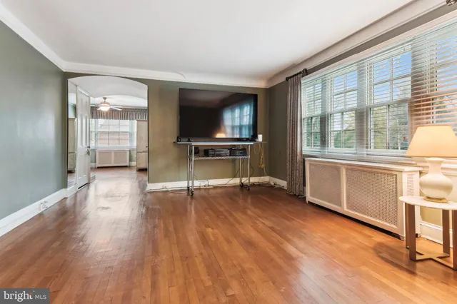 a view of a livingroom with wooden floor and furniture