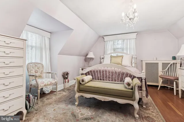 a bedroom with furniture and wooden floor