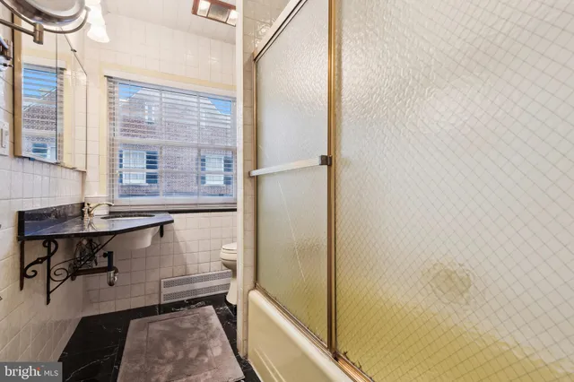 a bathroom with a sink and a window