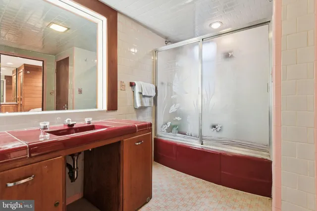 a bathroom with a double vanity sink mirror and shower