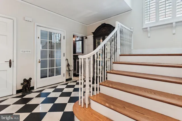 a view of a entrance door with wooden floor and a rug