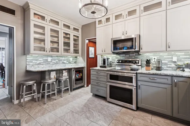 a kitchen with stainless steel appliances granite countertop a stove and a microwave oven