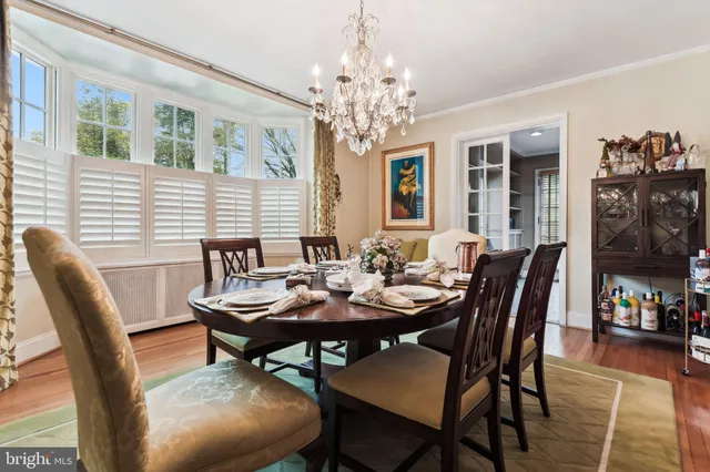 a view of a dining room with furniture wooden floor and a chandelier