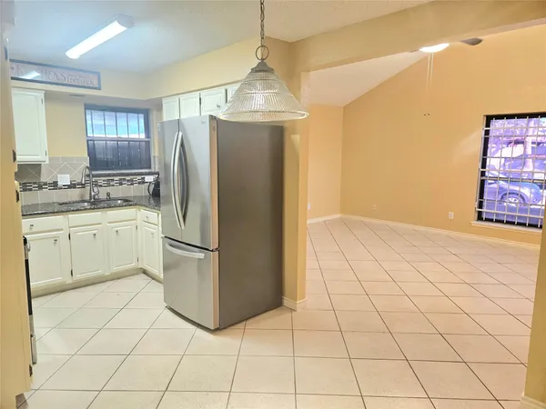 a kitchen with cabinets and stainless steel appliances