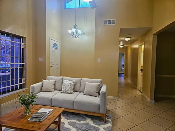 a living room with furniture and a dining table