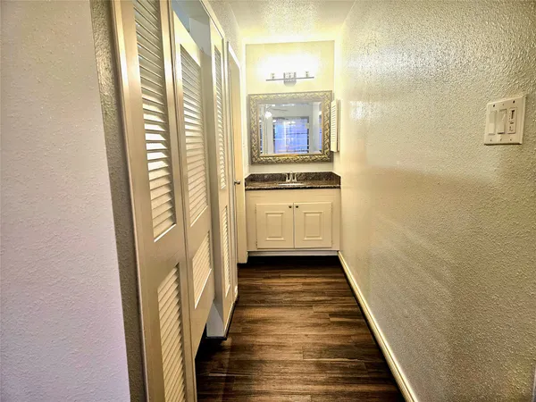 a bathroom with a granite countertop shower a toilet and a sink