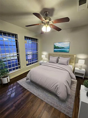 a bedroom with a bed and a large window