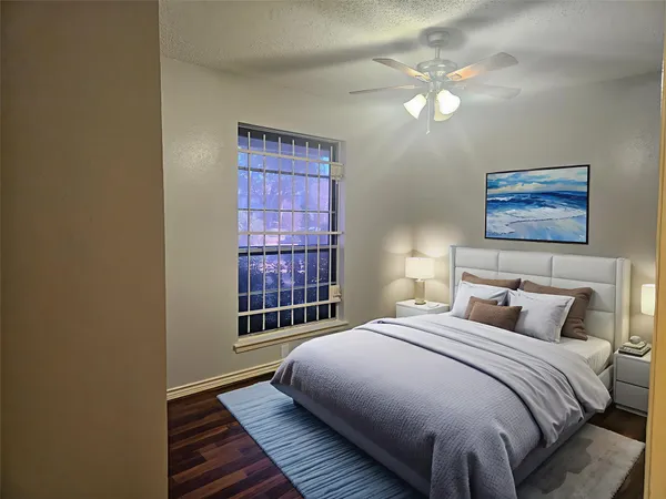 a spacious bedroom with a bed and a window